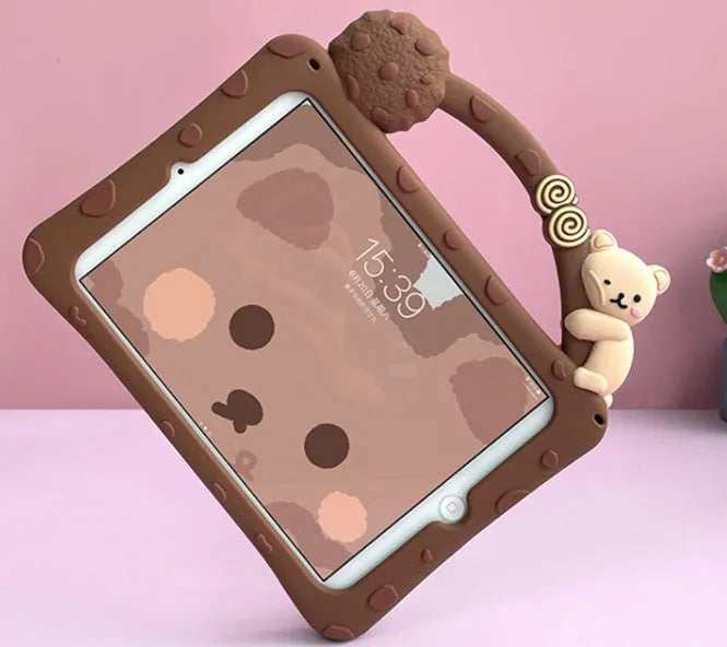 Brown cartoon-style silicone sleeve with a folding stand for an iPad tablet on a wooden table.