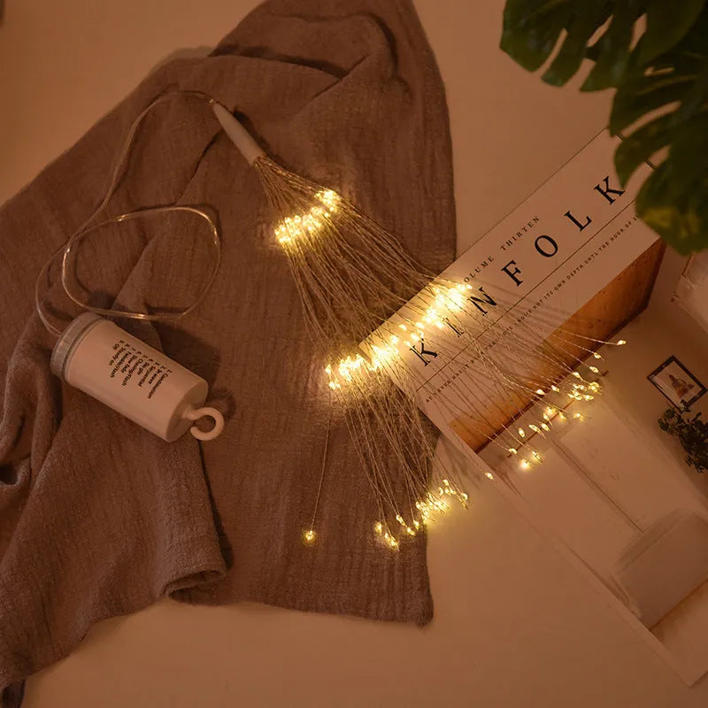 Solar-powered LED meteor shower string light with multiple warm white bulbs for outdoor garden decoration.