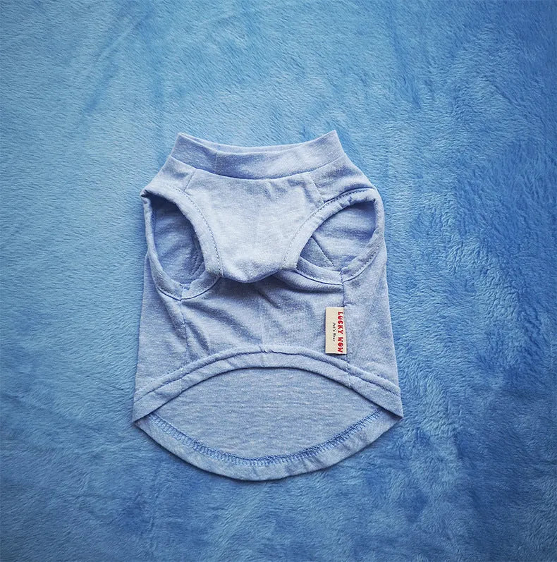 Dark blue cotton dog vest on a small dog with breathable fabric and slip-on design
