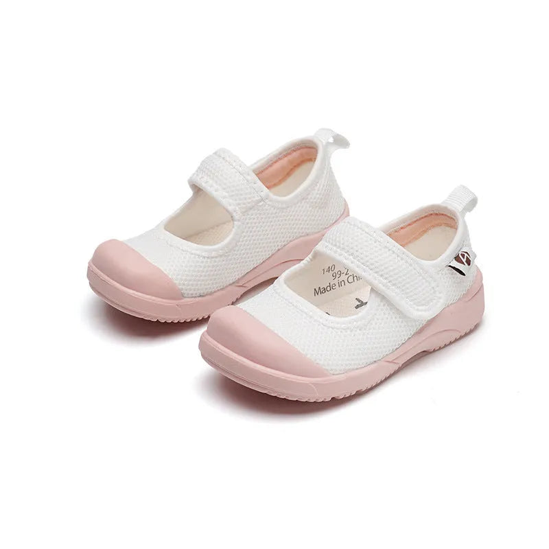 White children's cloth shoes with a breathable mesh upper and a Velcro strap fastening.