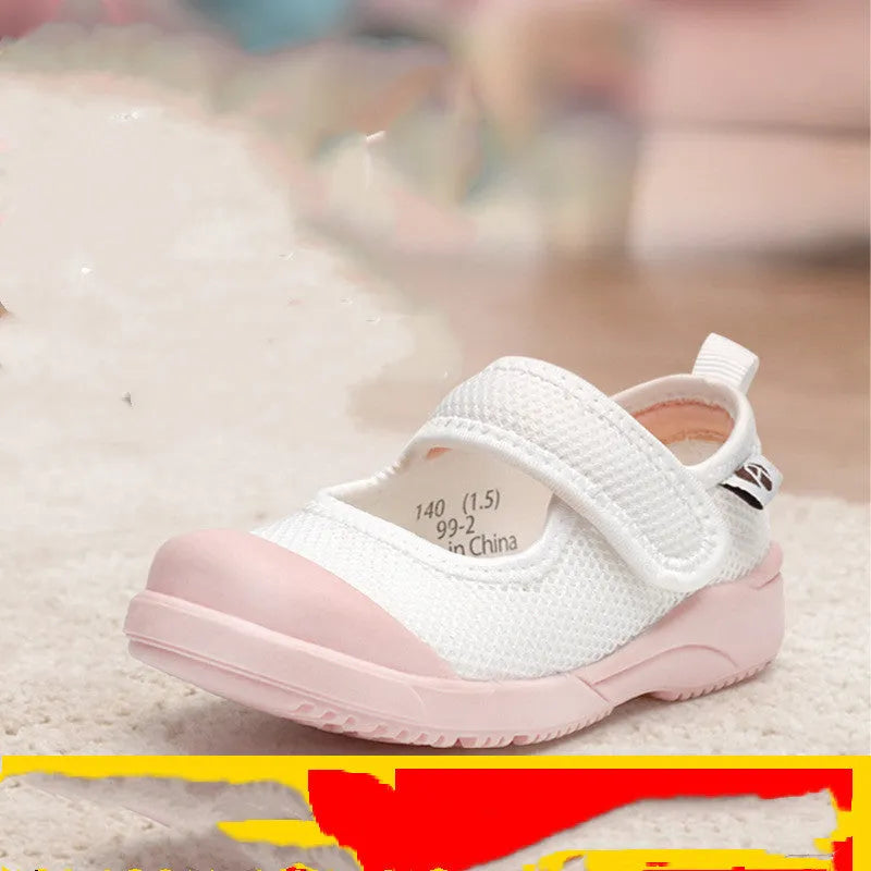White children's cloth shoes with a breathable mesh upper and a Velcro strap fastening.