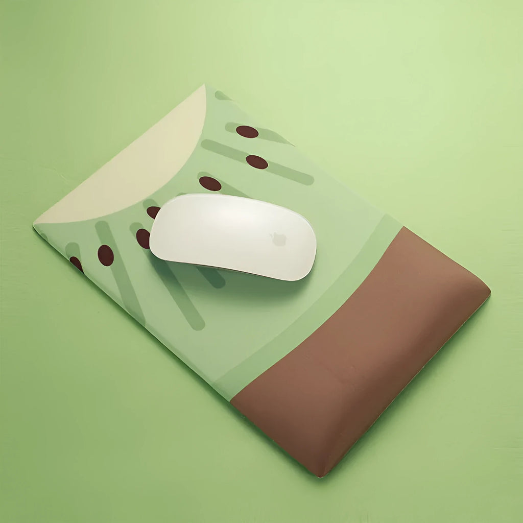 Green kiwi-shaped mouse pad with thick wrist support on a desk