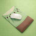 Green kiwi-shaped mouse pad with thick wrist support on a desk