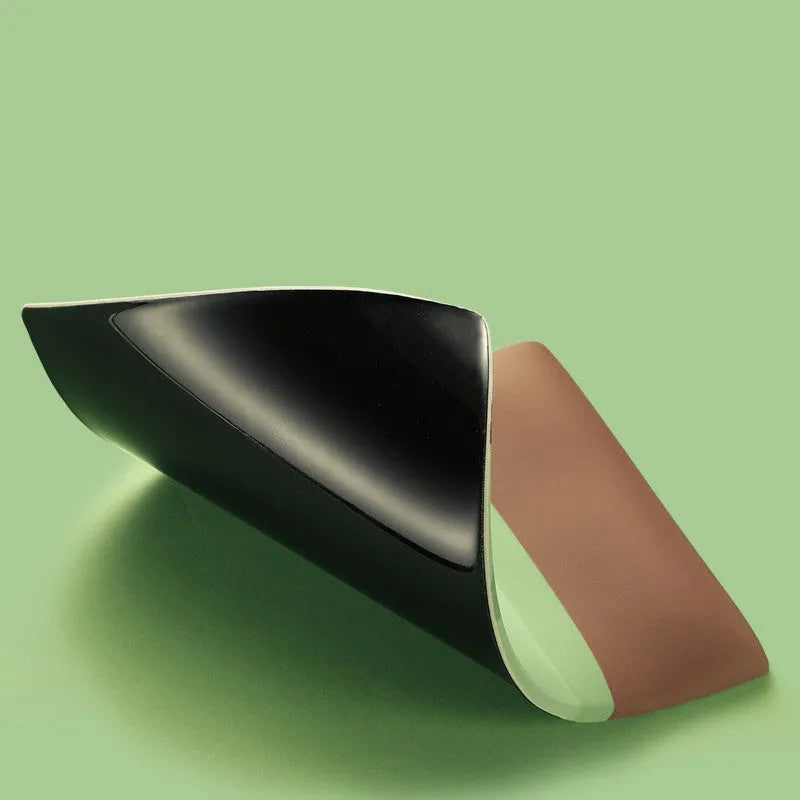 Green kiwi-shaped mouse pad with thick wrist support on a desk