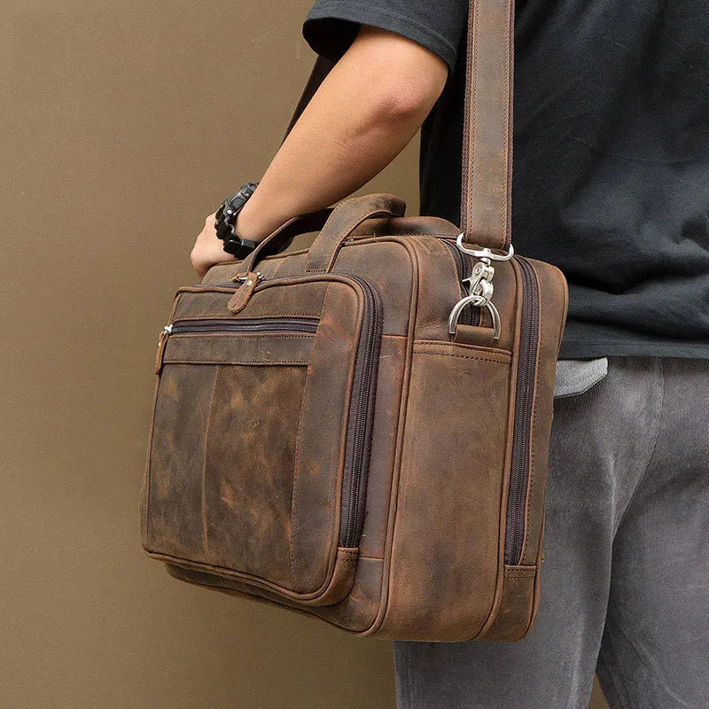Men's dark brown Crazy Horse leather laptop bag with double handles and zip closure on a neutral background