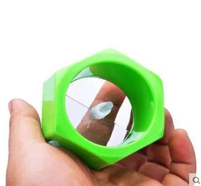 Yellow and green manual spiral vegetable cutter kitchen tool on a kitchen counter