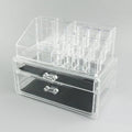 Clear foldable acrylic storage box with transparent sides, shown empty and collapsed flat.