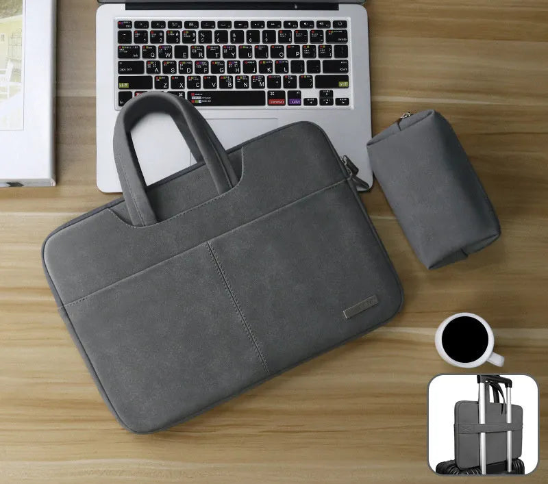 Dark grey PU leather laptop bag open to show padded compartment and internal organiser pockets.
