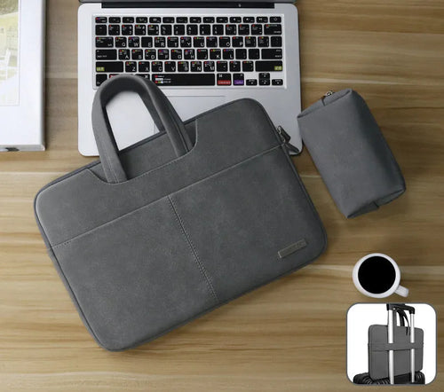 Dark grey PU leather laptop bag open to show padded compartment and internal organiser pockets.