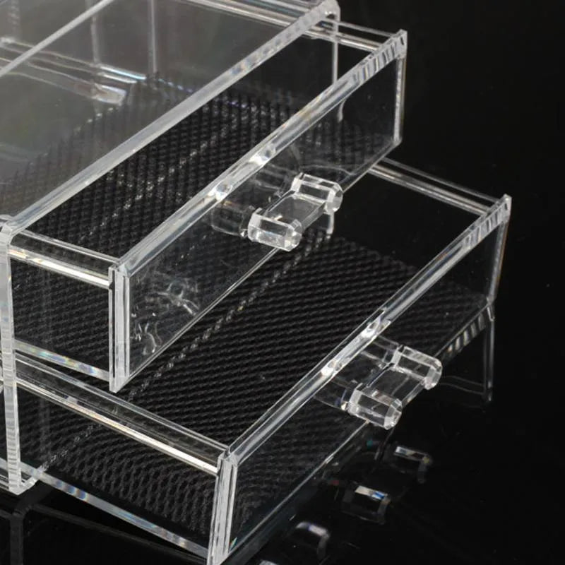 Clear foldable acrylic storage box with transparent sides, shown empty and collapsed flat.