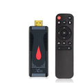 Compact black TV stick dongle set-top box with remote control, HDMI cable, and power supply.