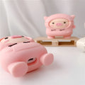 Pink silicone AirPods case cover with cartoon pig design and a metal carry hook.