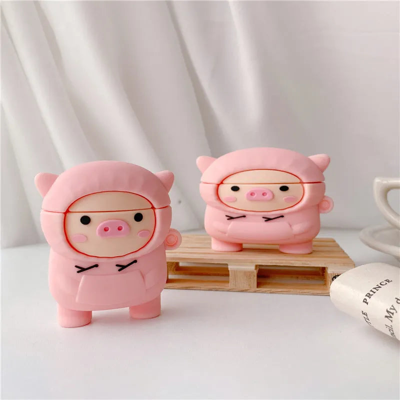 Pink silicone AirPods case cover with cartoon pig design and a metal carry hook.