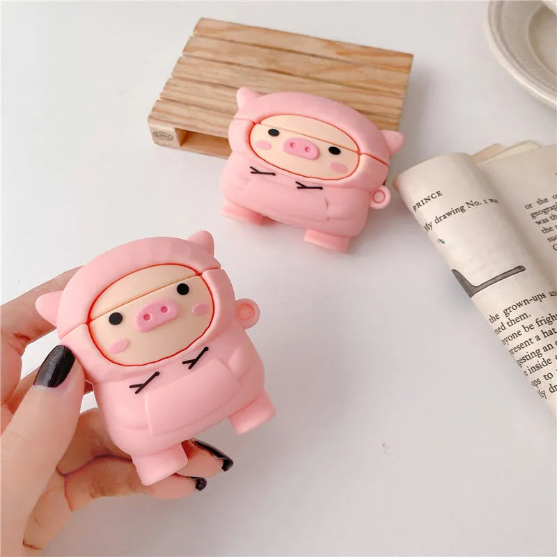 Pink silicone AirPods case cover with cartoon pig design and a metal carry hook.