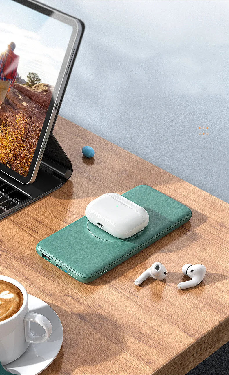 Mint green Maiduo Magsafe magnetic power bank clipped to the back of an iPhone