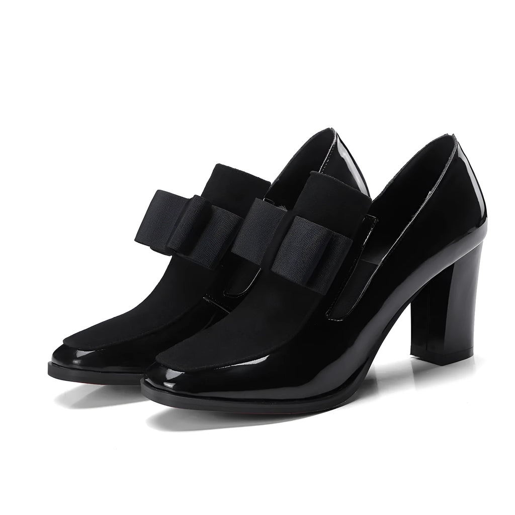 Black patent leather women's high heel shoes with a thick heel and square toe on a rubber sole