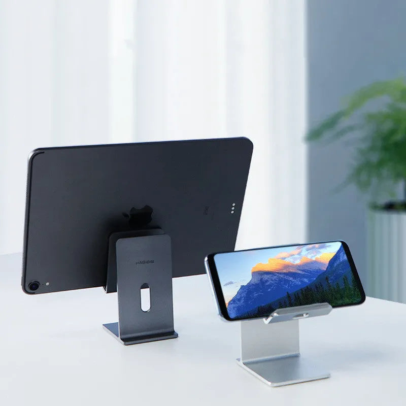 Dark Space Grey zinc alloy mobile phone holder with adjustable lazy bracket arm holding a smartphone on a desk.
