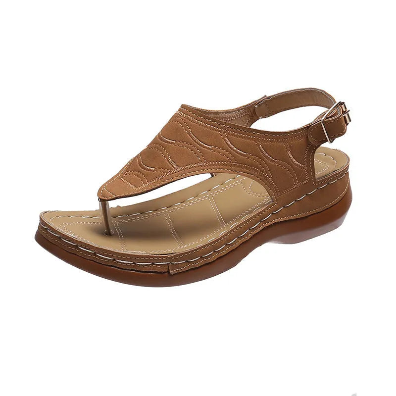 Women's wedge heel flip flop sandals with an adjustable back strap in solid black.