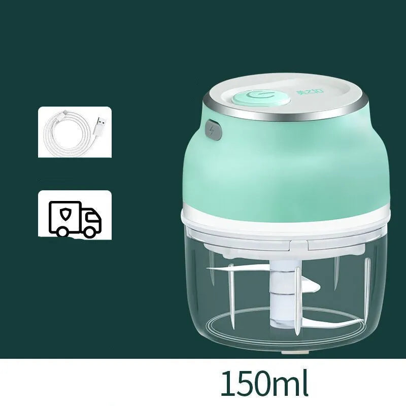 Portable white electric food chopper with transparent cup and stainless steel blades on a kitchen counter.