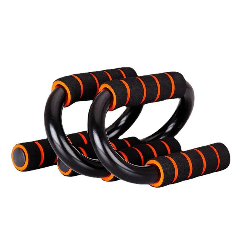 Black parallettes push up stands made of steel pipe with foam grips, 19x13x13cm, on a flat surface