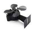 Black Yotsuba style thermodynamic fireplace fan on a fireplace, showing metal blades and compact 17x11.5x25cm size.