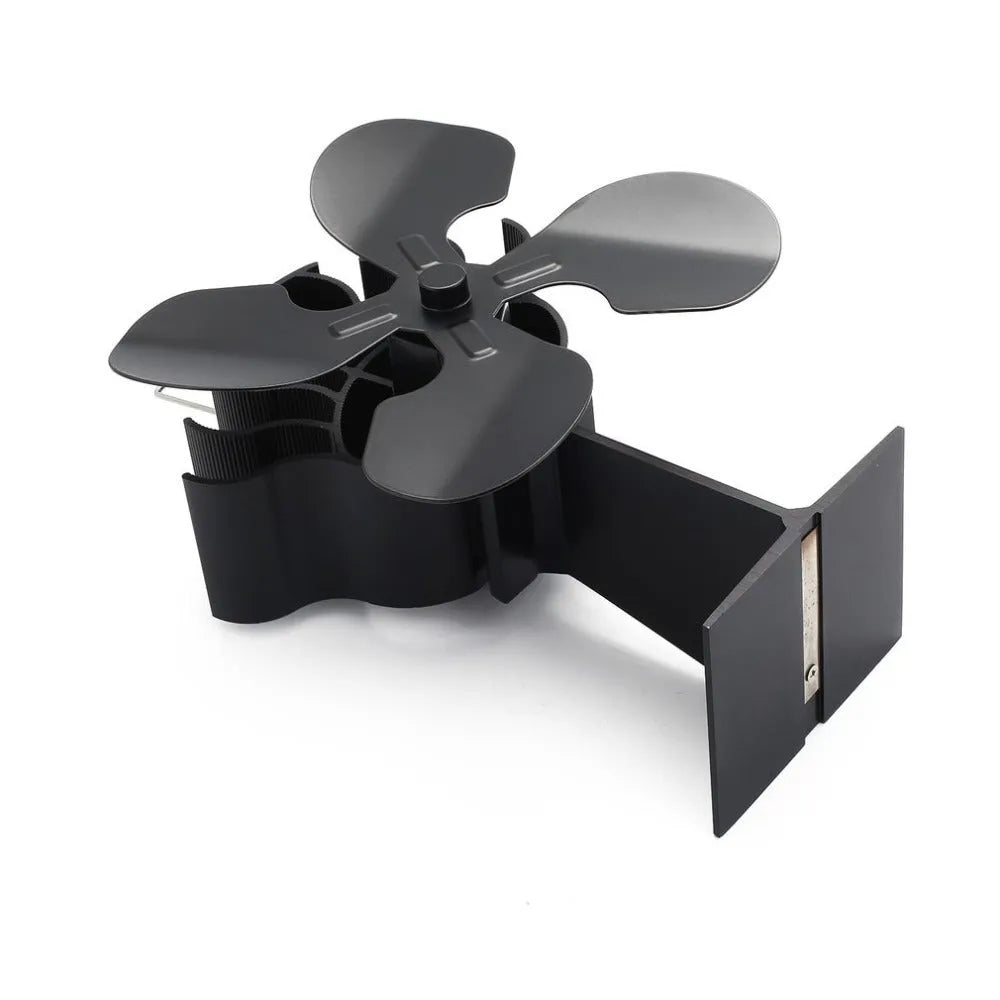 Black Yotsuba style thermodynamic fireplace fan on a fireplace, showing metal blades and compact 17x11.5x25cm size.