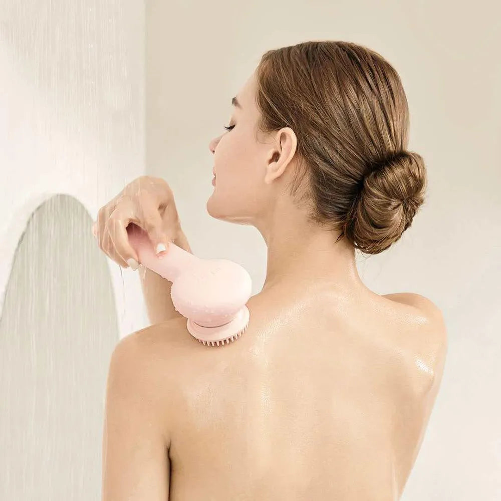 Grey and pink inFace automatic electric shower brush with four rotating brush heads on display.