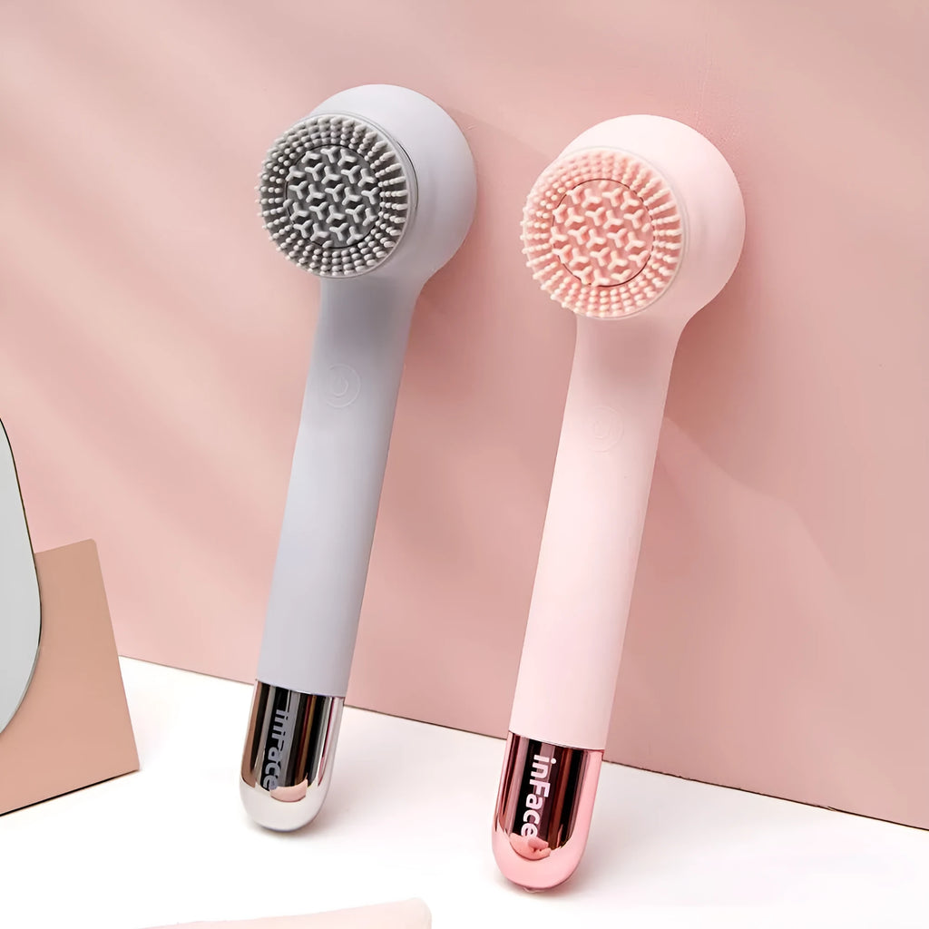 Grey and pink inFace automatic electric shower brush with four rotating brush heads on display.