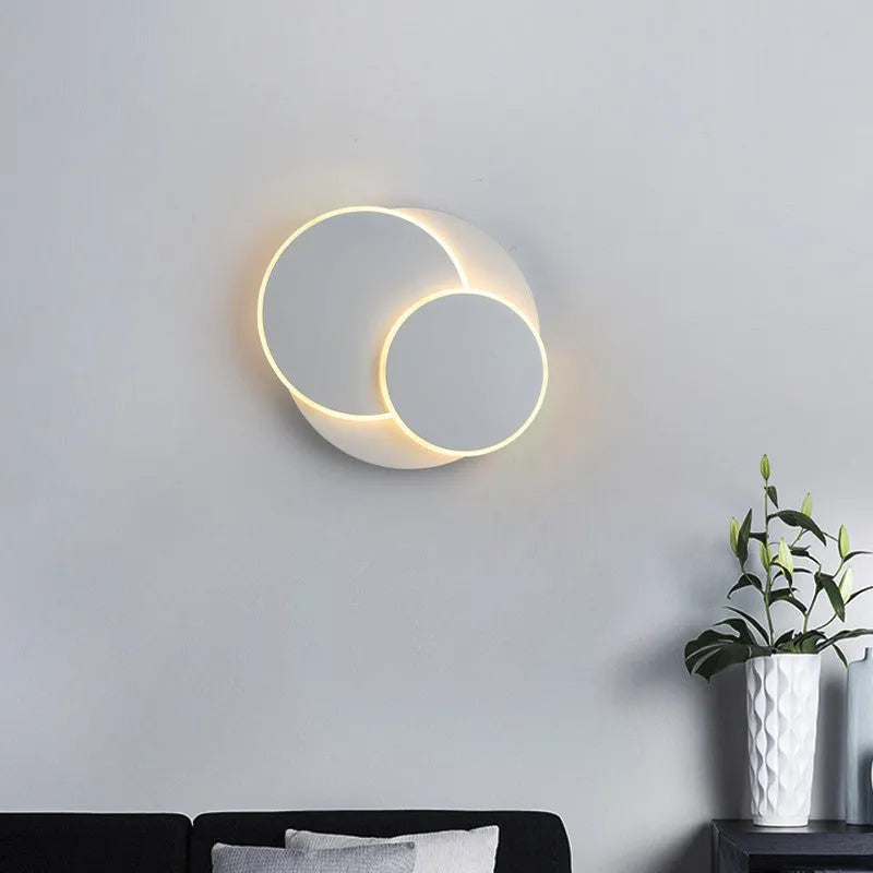 Modern round acrylic wall lamp in black or white, shown in small, medium, and large size options.