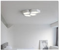Geometric shaped iron shade LED light fixture with remote control in black or white frame.