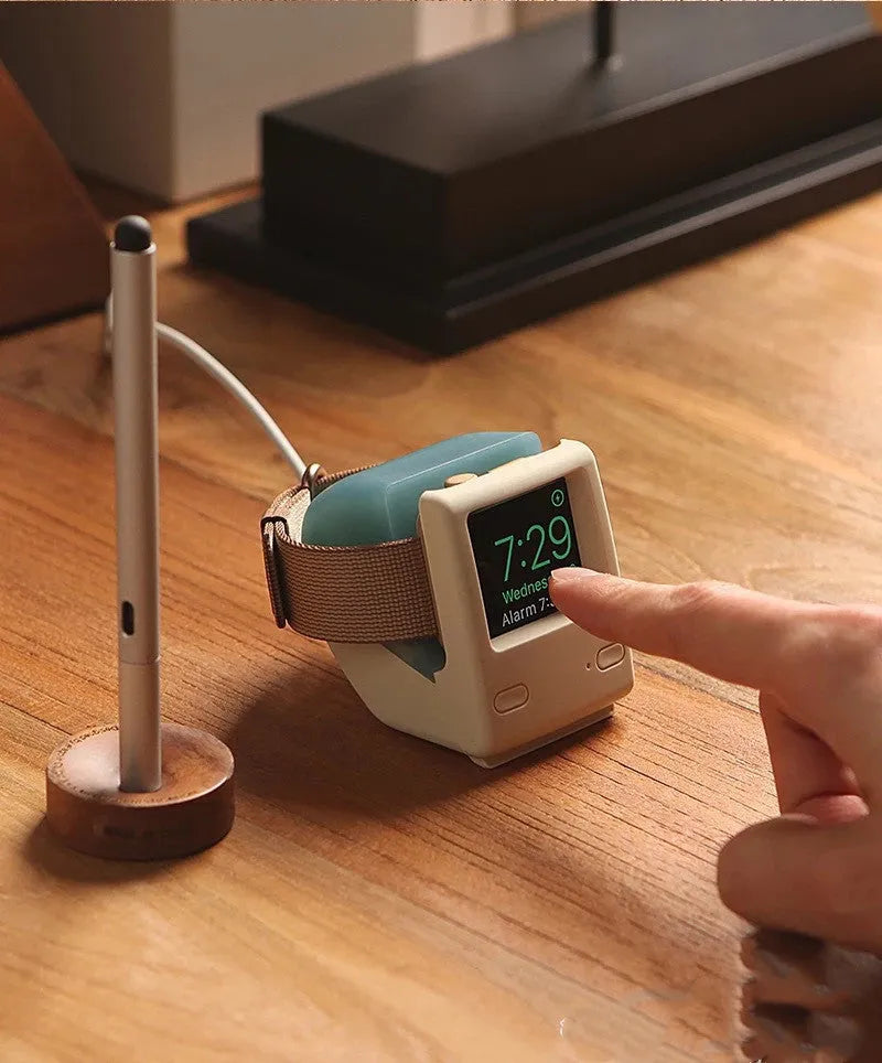 Silicone Apple Watch charging stand in Mint Green, holding a watch in upright position on a desk
