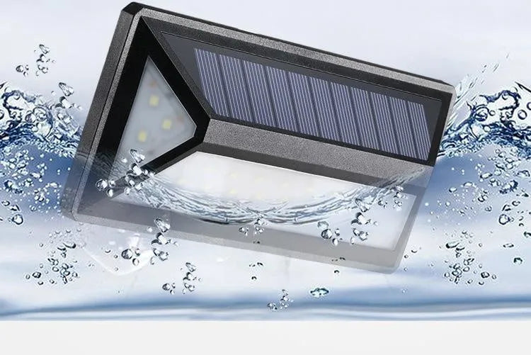 Black solar wall light with 33 LEDs, IP65 rated, measuring 166x75x30mm, mounted on an exterior wall