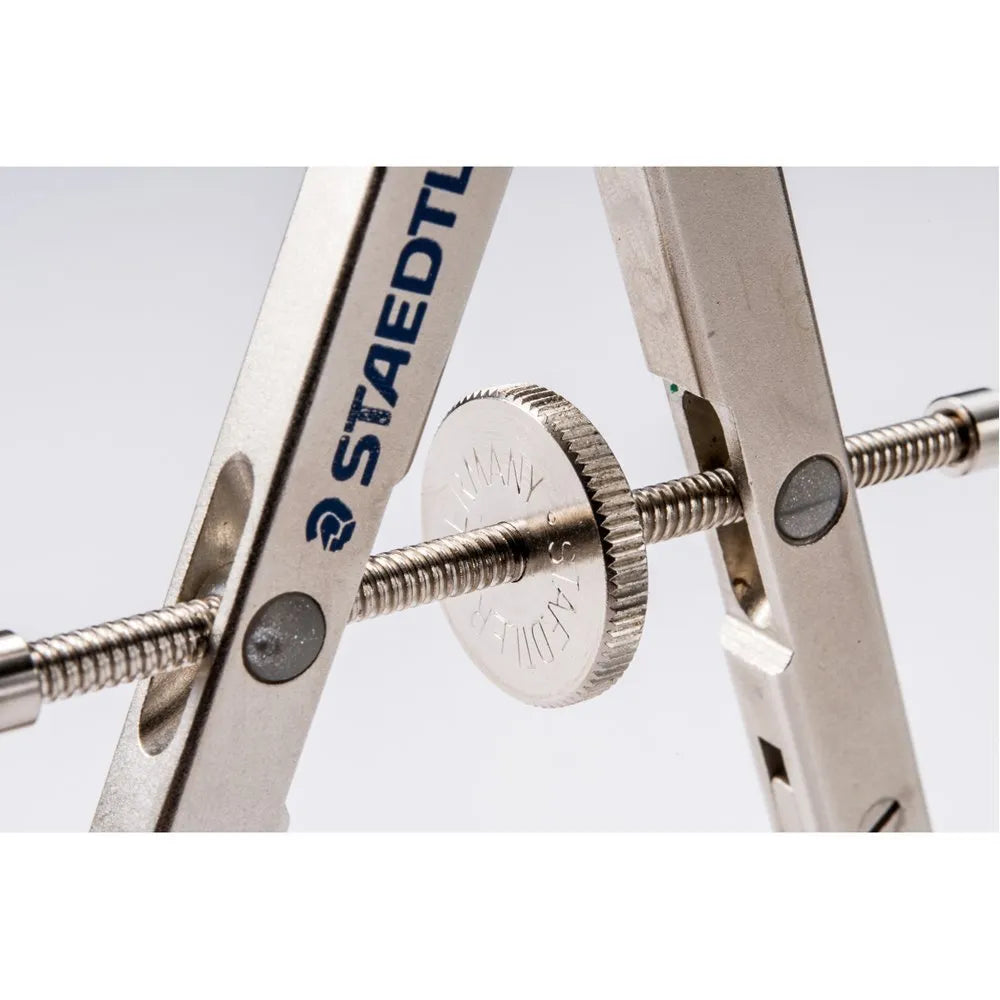STAEDTLER 551 01 metal car compass with extended telescopic rod on technical drawing paper.
