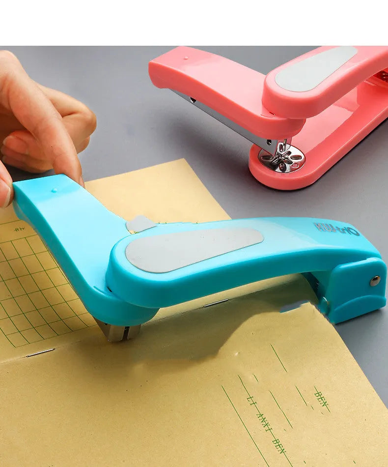 360-degree rotatable stapler in dark blue on a desk with papers, showing its rotating head mechanism.