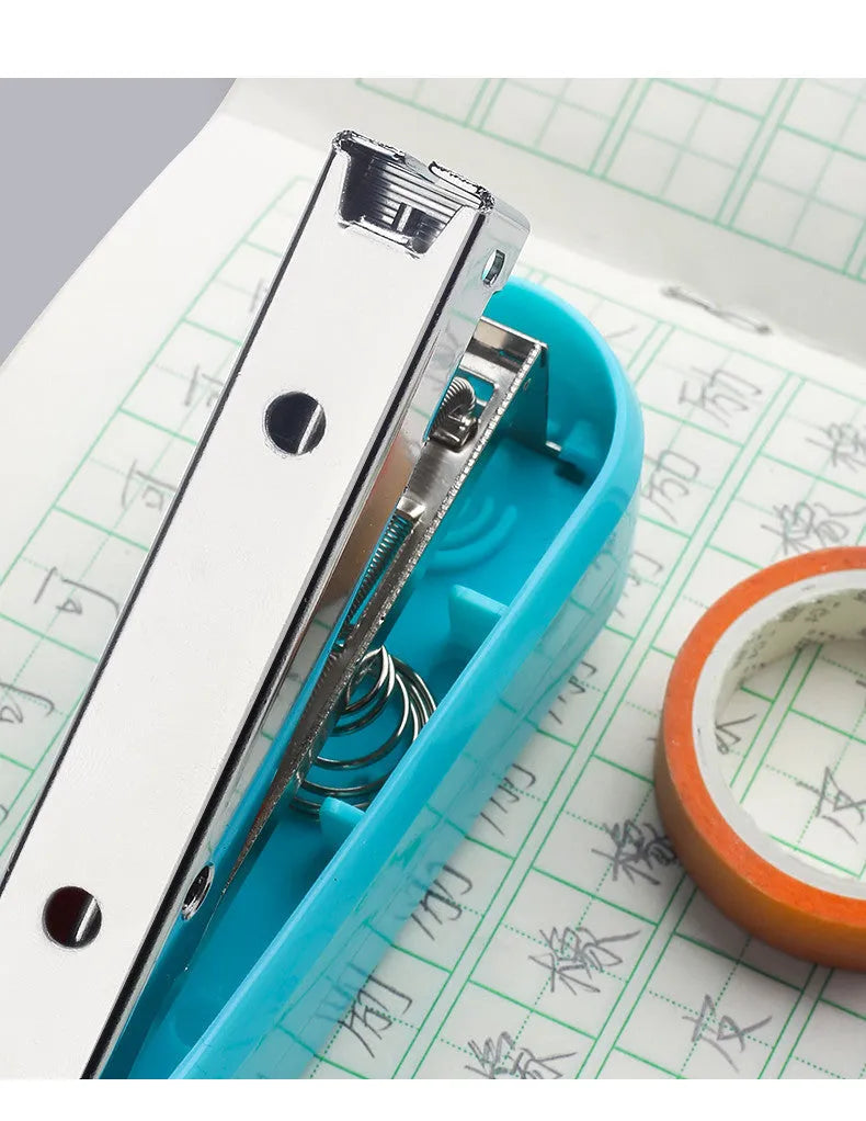 Black 360-degree rotatable desk stapler showing metal nail outlet and centre seam binding function.