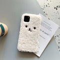 Brown embroidered plush bear face on a clear TPU iPhone case, showing precise cutouts for camera and ports.