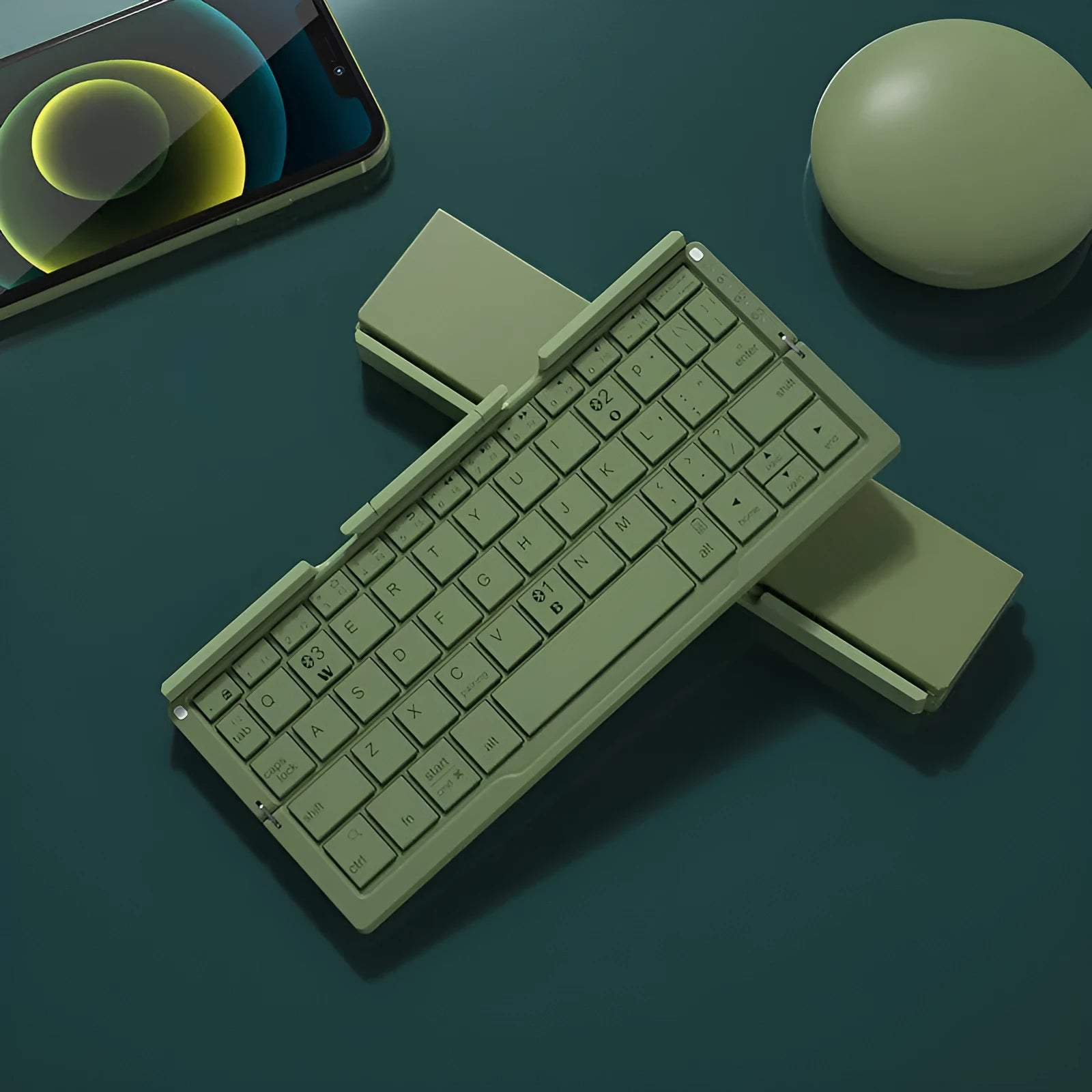 Silver aluminium folding Bluetooth keyboard shown open with phone on stand and folded to pocket size