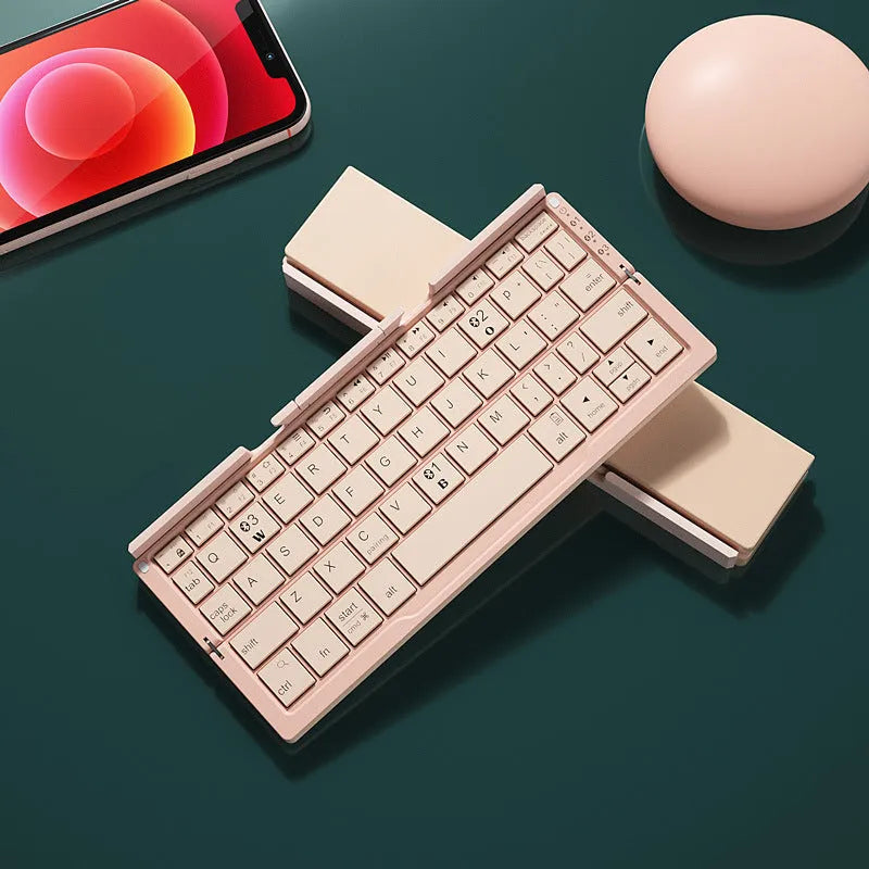 Silver aluminium folding Bluetooth keyboard shown open with phone on stand and folded to pocket size