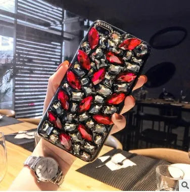 Clear rhinestone decorated iPhone case on mobile phone showing sparkling elements and transparent TPU construction