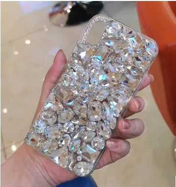 Clear rhinestone decorated iPhone case on mobile phone showing sparkling elements and transparent TPU construction