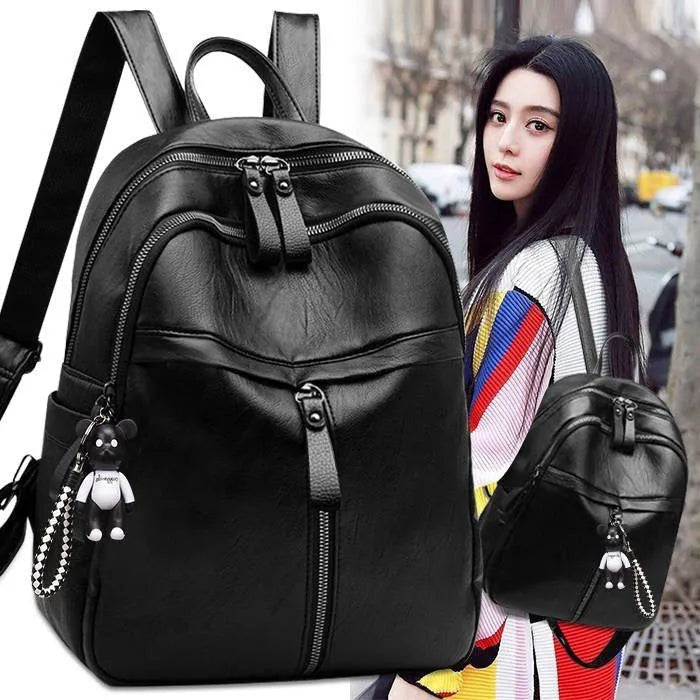 Black soft pu leather backpack with double straps, shown open to display internal organisation.