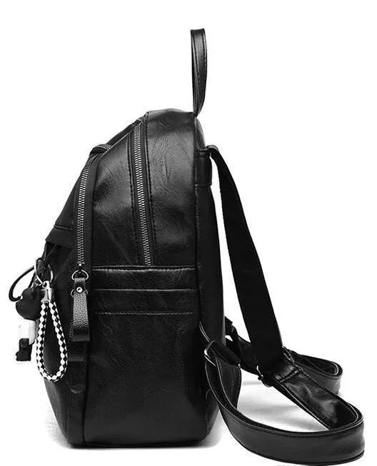 Black soft pu leather backpack with double straps, shown open to display internal organisation.