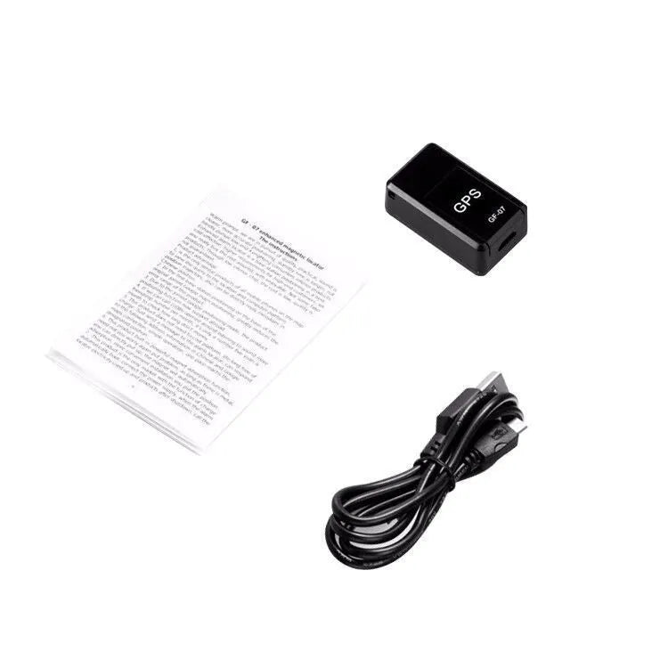 Small black magnetic GPS tracker device with USB cable for real-time vehicle and asset tracking.