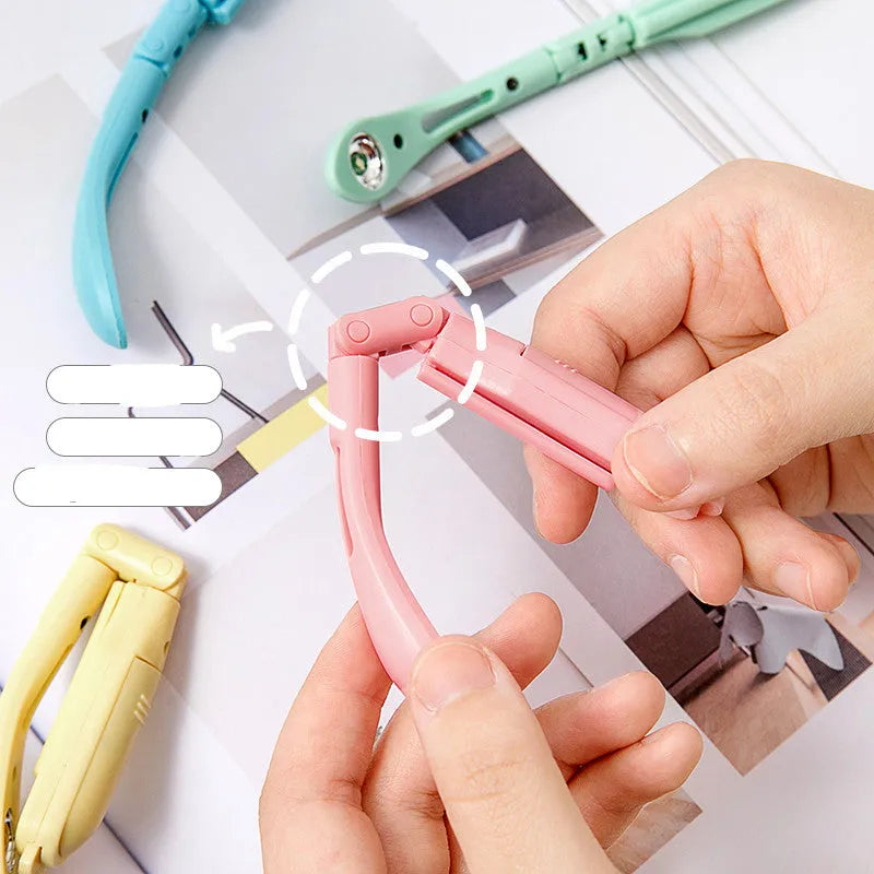 A folding book light with a clip, shown in yellow, blue, green, and pink colour options.