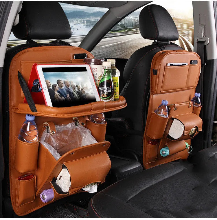 PU leather car seat back organiser with multiple pockets and a detachable bottom waste bin, hanging behind a car headrest.
