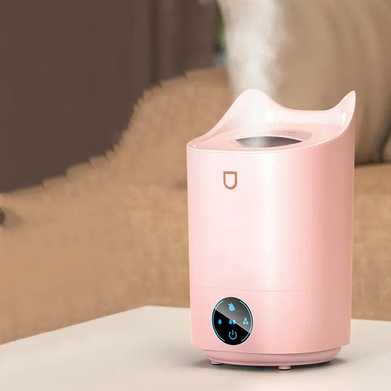 Coral Pink double spray humidifier with three mist outlets and USB cable on a wooden table.