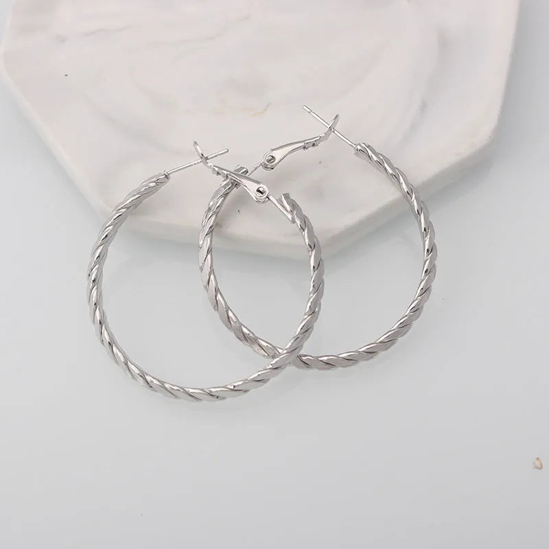 Simple geometric metal earrings for women in golden colour with electroplating finish