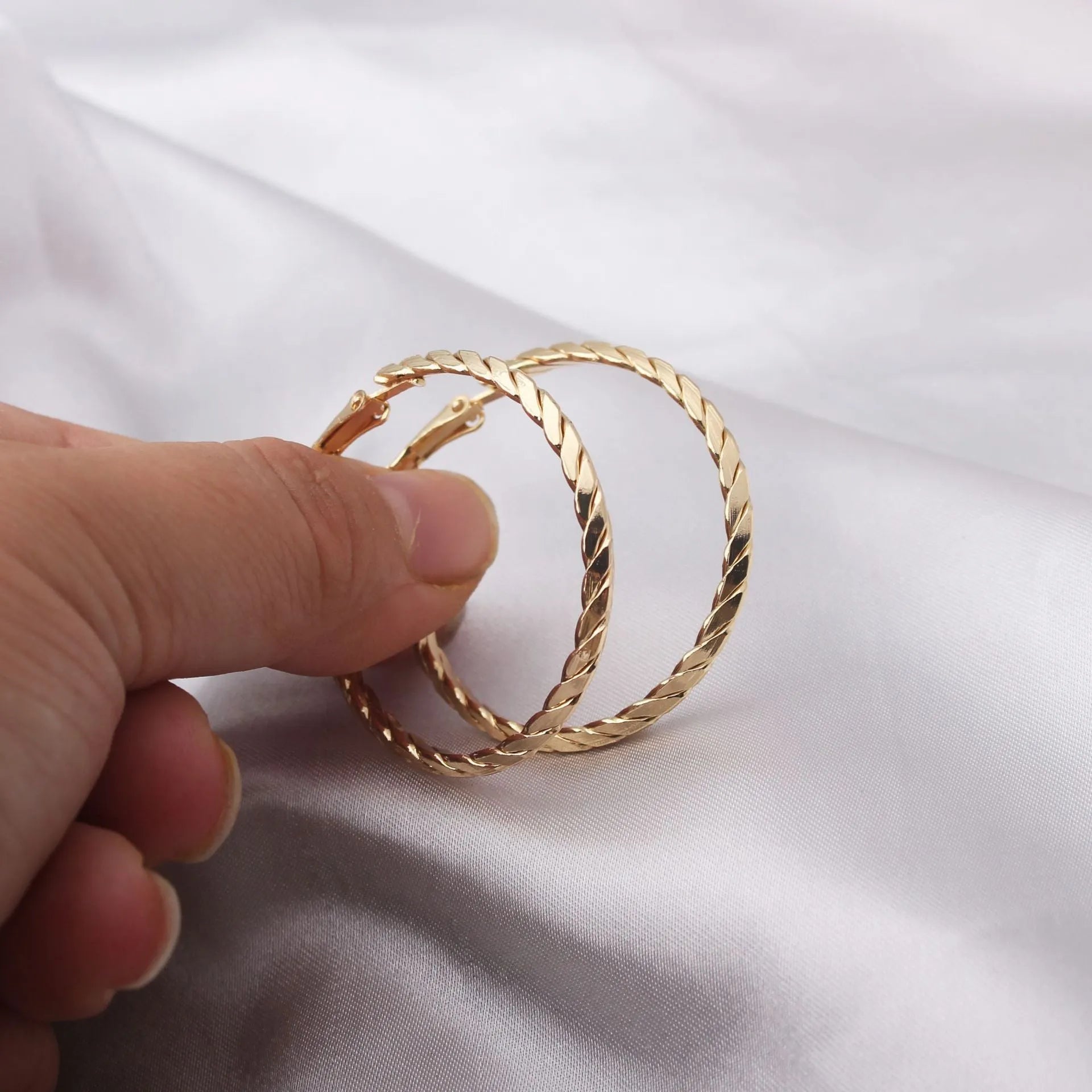 Simple geometric metal earrings for women in golden colour with electroplating finish