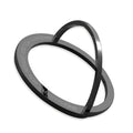 Round zinc alloy mobile phone holder on a desk, 56mm diameter, available in black or silver