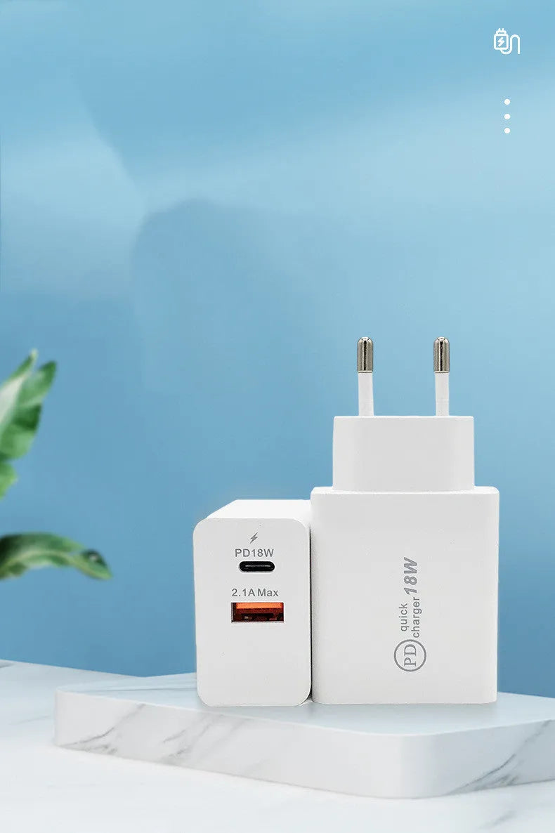 White 18W USB-C fast wall charger with bare metal US plug prongs isolated on white background